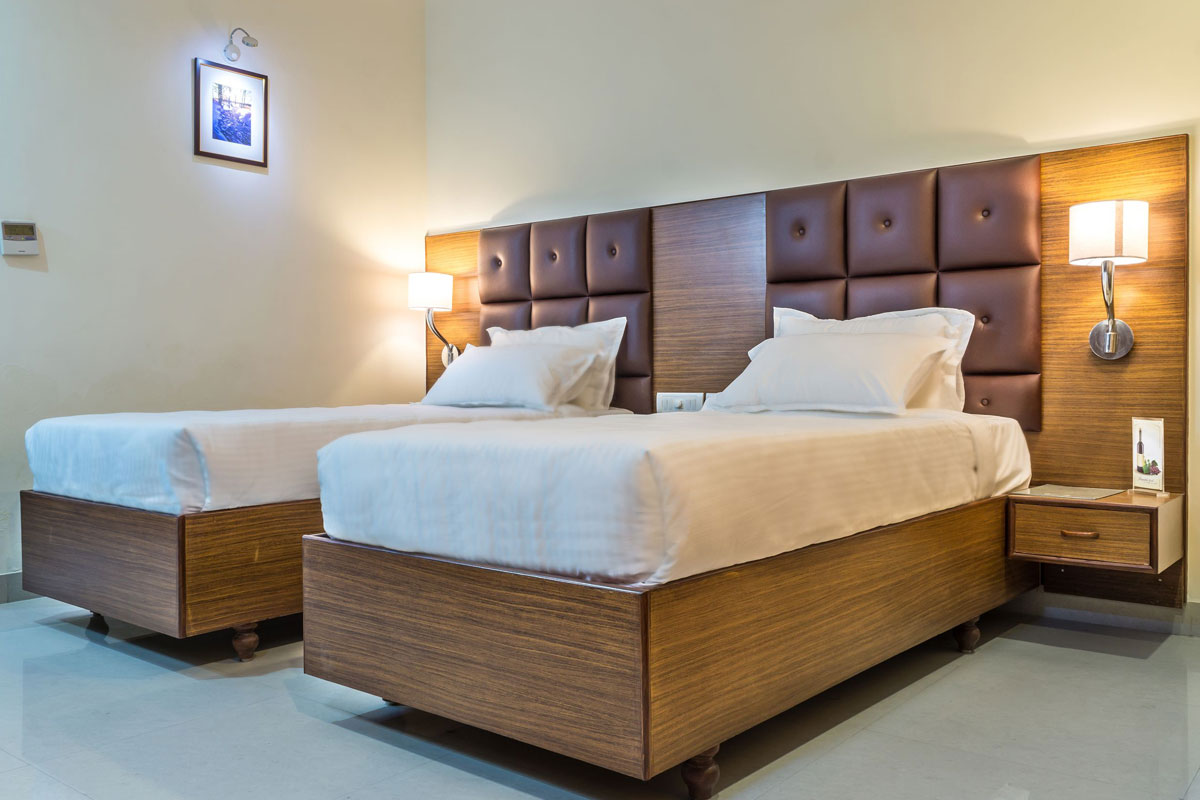 Standard room beds at Hotel Saptagiri